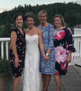 Dr. Jessica Bishop stands with longtime team members Sandra, Laurie, and Krystal, celebrating 25 years of caring for patients and serving the dental practice together.